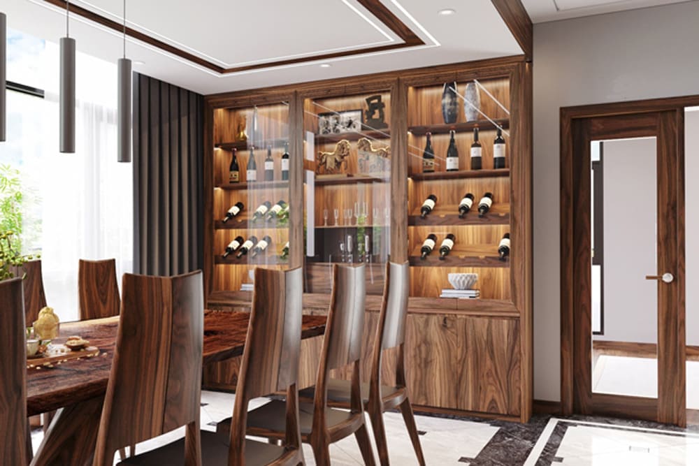 Thiết kế nội thất phòng ăn sang trọng với bộ bàn ghế gỗ óc chó, tủ rượu lớn và hệ đèn led âm trần, mang lại không gian ăn uống ấm cúng nhưng không kém phần đẳng cấp.